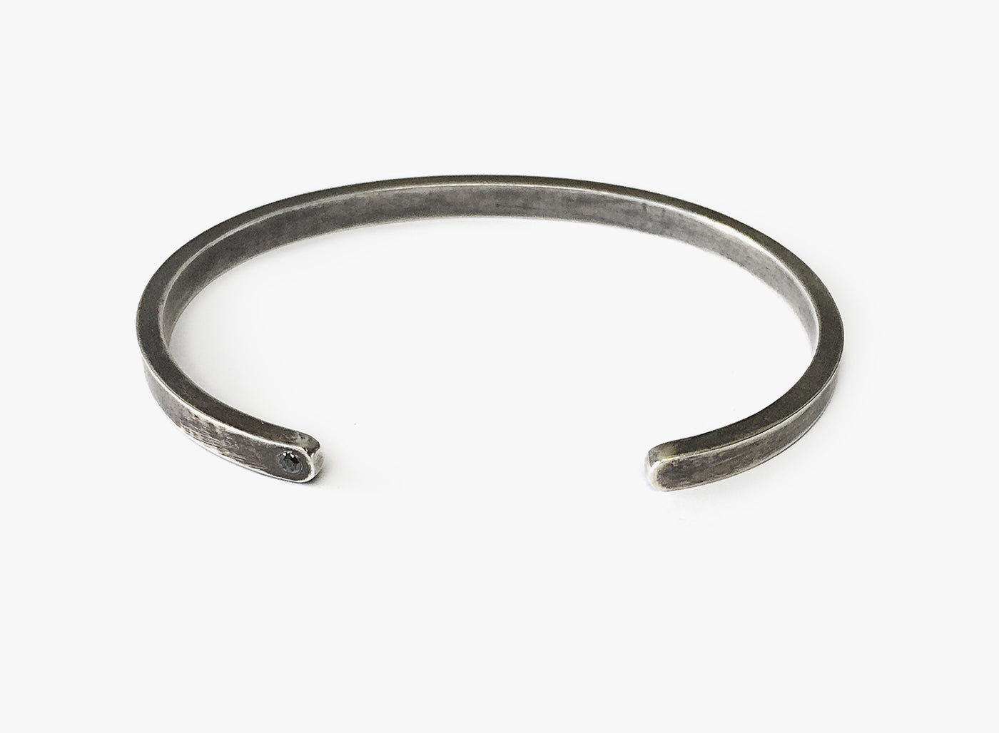 GEM STONES BRACELET 056: this sterling silver cuff is finished with a .09ct black diamond on its tip. 