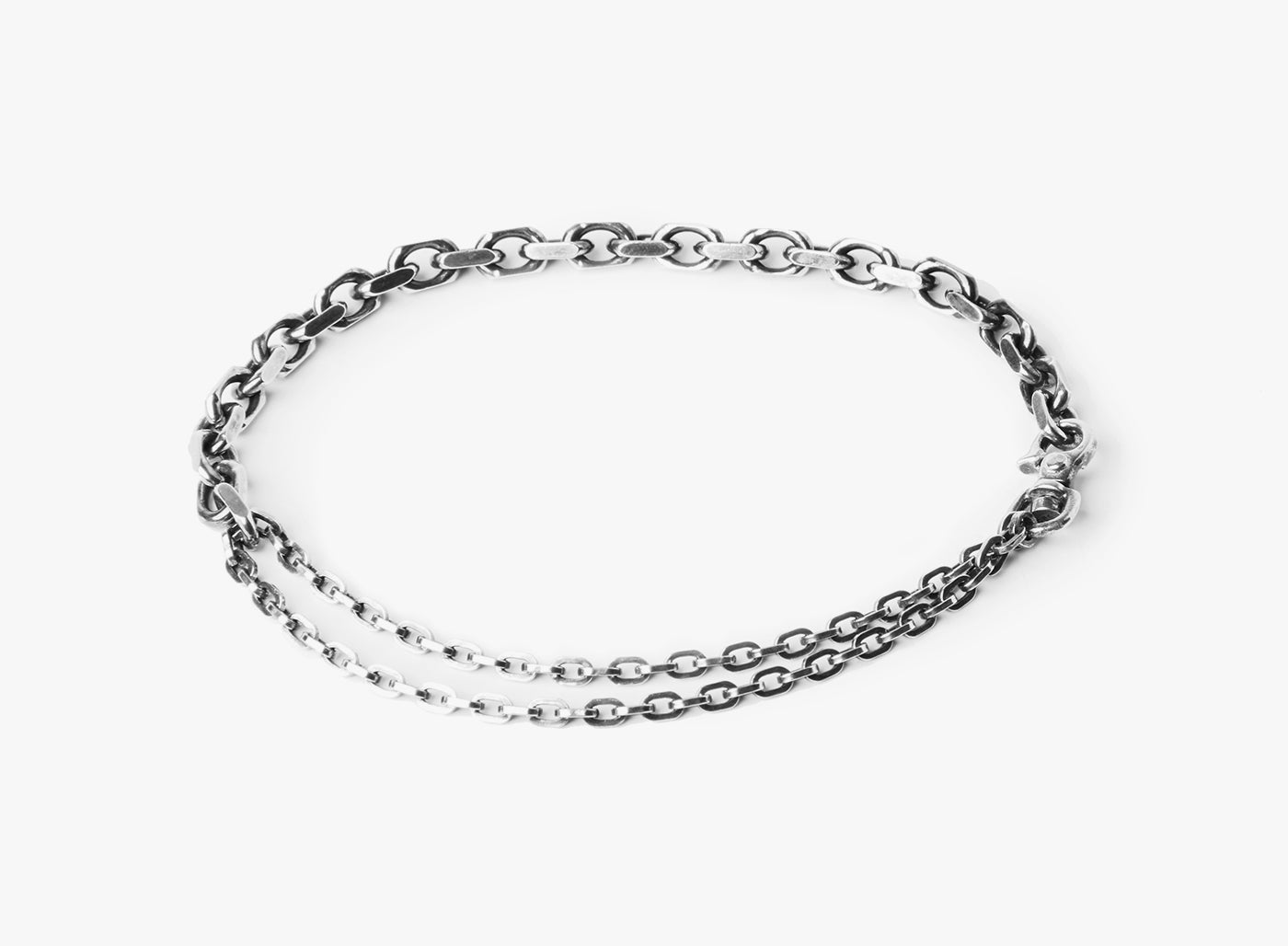 MIXED CHAIN BRACELET 211: a drawn cable chain connects to a double wrap flat cable and is fastened by a carabiner lobster clasp.