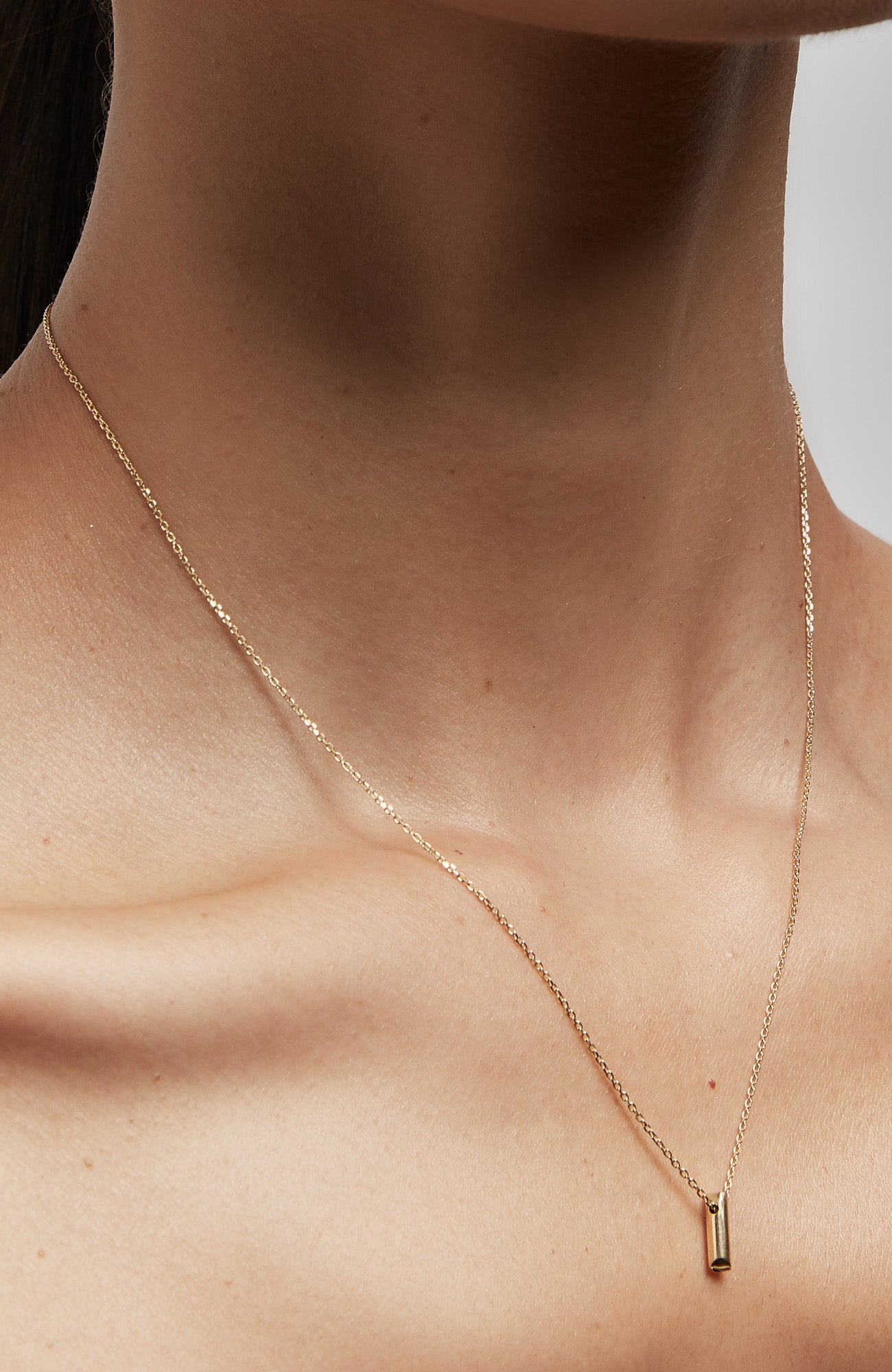 an 18k gold bar hangs from a flat cable chain and is finished with a signature thumbprint amulet. it is constructed in our lower east side studio using reclaimed 18k gold. Each piece is constructed in our lower east side studio using reclaimed 18k gold.