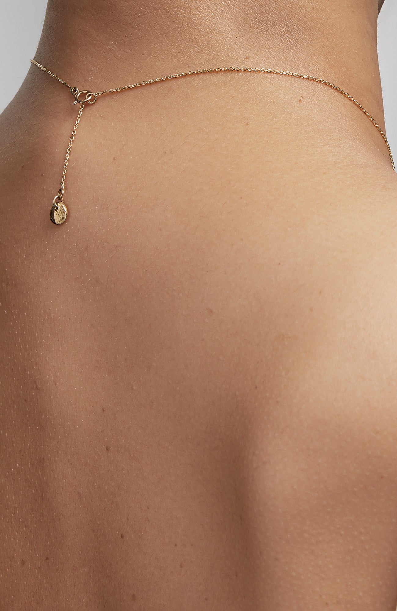 an 18k gold bar hangs from a flat cable chain and is finished with a signature thumbprint amulet. it is constructed in our lower east side studio using reclaimed 18k gold. Each piece is constructed in our lower east side studio using reclaimed 18k gold.