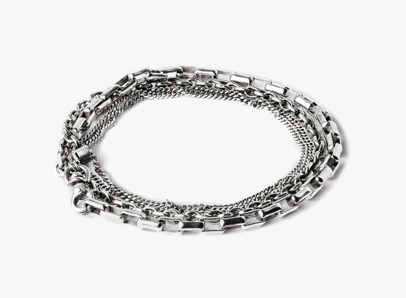 our signature multi wrap bracelet is adjustable and consists of varying sterling silver chains including a box, flat cable, and curb chain. when worn, it appears as if you're wearing 3 different pieces