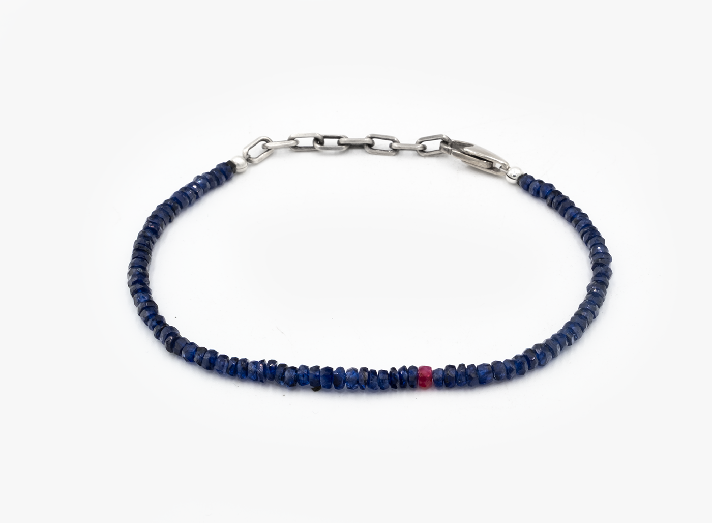 Sapphire blue beaded bracelet with a silver clasp on a white background