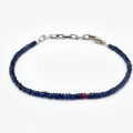 Sapphire blue beaded bracelet with a silver clasp on a white background