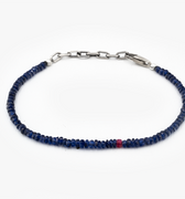 Sapphire blue beaded bracelet with a silver clasp on a white background