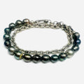 choker features a strand of 8.5mm grade a black tahitian pearls that connect to a round cable chain. this piece can also be worn as a dual wrap bracelet.