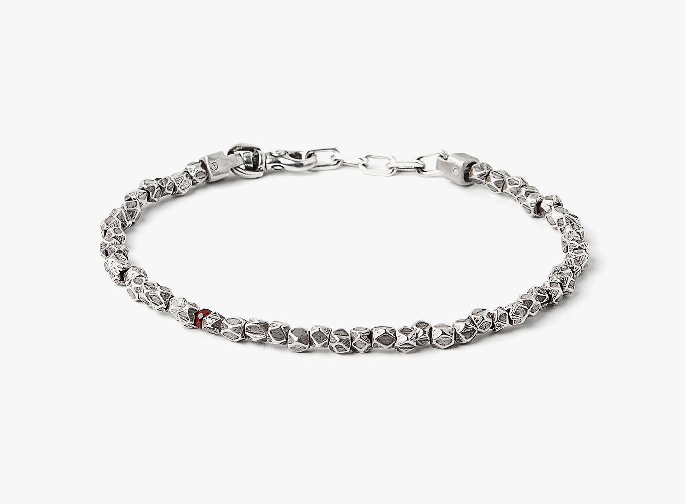 asymmetrical sterling beads are disrupted by a single ruby on this adjustable bracelet