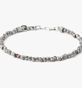 asymmetrical sterling beads are disrupted by a single ruby on this adjustable bracelet