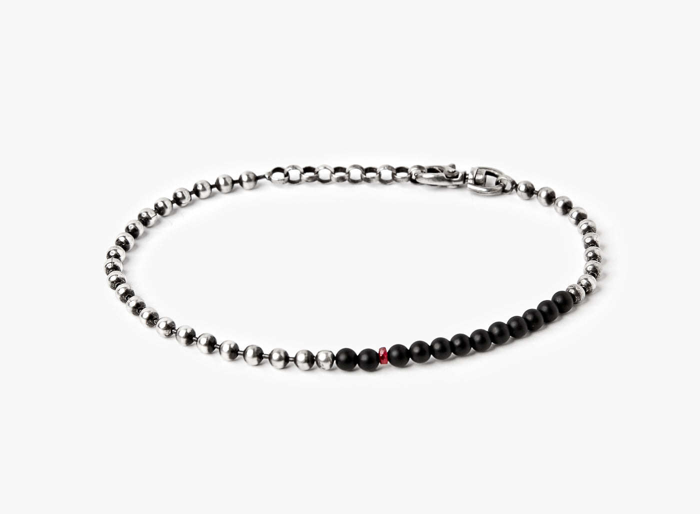 adjustable solid sterling ball chain connects to a strand of onyx stones and is finished with a single ruby