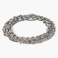 adjustable, multi wrap bracelet features a strand of silver chips connected to a curb chain and round cable chain and finished with a single ruby