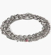 adjustable, multi wrap bracelet features a strand of silver chips connected to a curb chain and round cable chain and finished with a single ruby