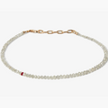 adjustable grey diamond bracelet is finished with a single ruby and 18k gold links