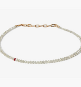 adjustable grey diamond bracelet is finished with a single ruby and 18k gold links