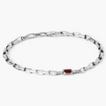 adjustable bracelet features a single offset emerald-cut garnet that sits along a sterling box chain