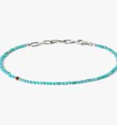 adjustable turquoise stone bracelet is finished with a signature single ruby