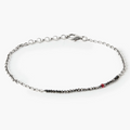 adjustable strand of 1.5mm black diamonds connect to a sterling cable chain and is finished with a single ruby