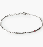 adjustable strand of 1.5mm black diamonds connect to a sterling cable chain and is finished with a single ruby