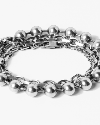 adjustable triple wrap bracelet features three types of sterling silver chain with an 18k gold accent piece