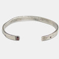 hand-forged, beaten and distressed cuff features an emerald cut garnet stone and a 2mm inset ruby