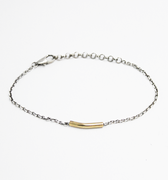 adjustable bracelet features a hand forged .75" 18k gold tube that sits along a sterling silver bead chain