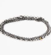 signature multi wrap bracelet features varying sterling anchor, cable, and ball chains that are offset with an 18k gold ring and sterling silver bar