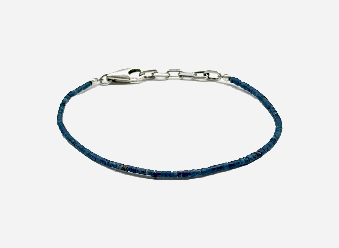 adjustable beaded lapis lazuli bracelet is finished with a signature single ruby