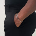 it is constructed in our lower east side studio using reclaimed sterling silver, which is then is oxidized - resulting in a darkened finish that will wear over time to a lighter, contrasting patina