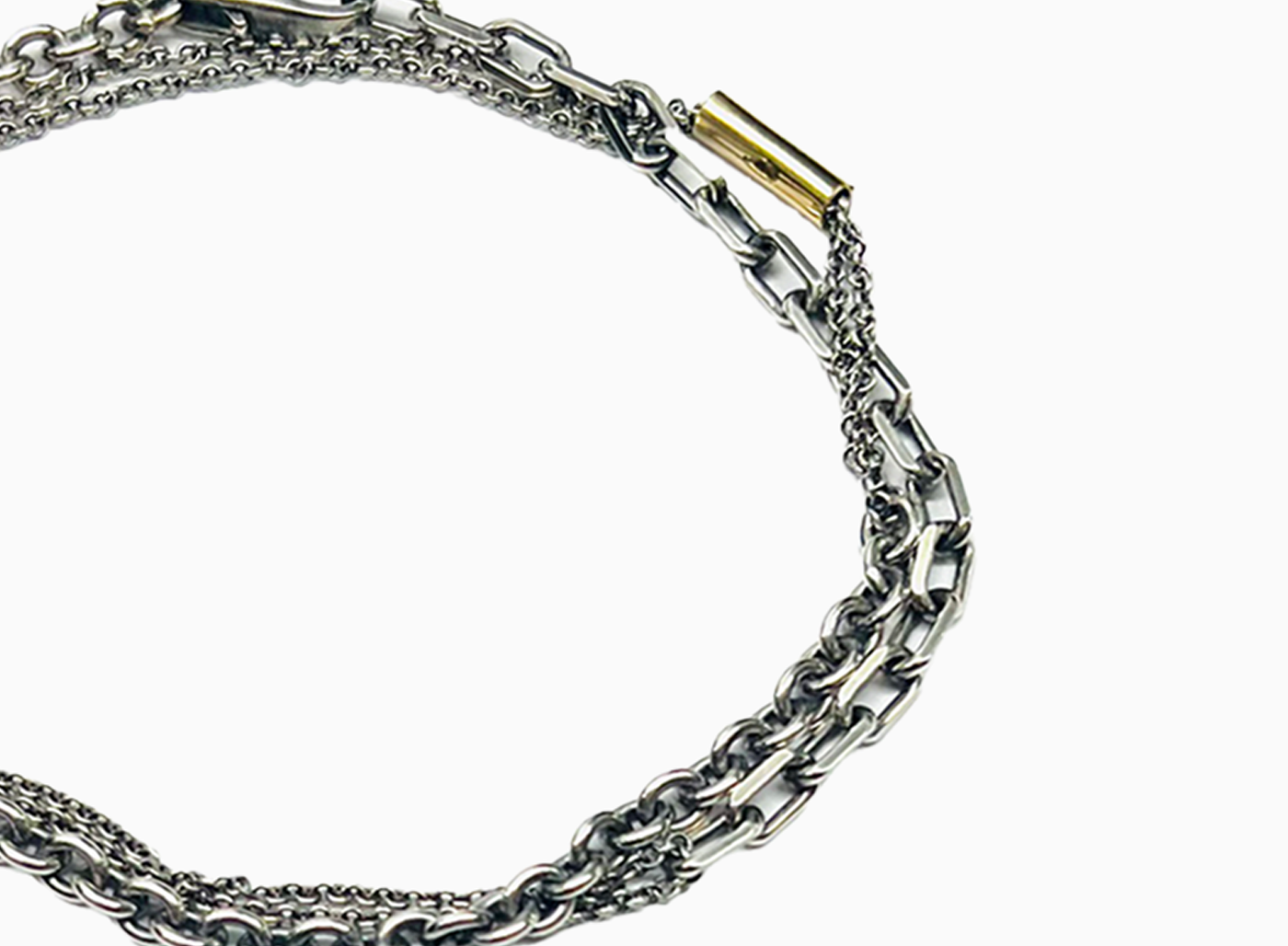 bracelet is comprised of three separate chains including a thin double strand cable chain, more dense single strand cable chain and an anchor chain, accented by an 18k yellow gold tube.
this piece can also be worn as a necklace.