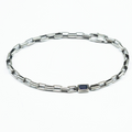 adjustable bracelet features a single offset emerald-cut iolite that sits along a sterling box chain