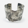 distressed 3" cuff is fabricated using sterling silver. it is hand-hammered and distressed featuring small holes throughout the body of the cuff