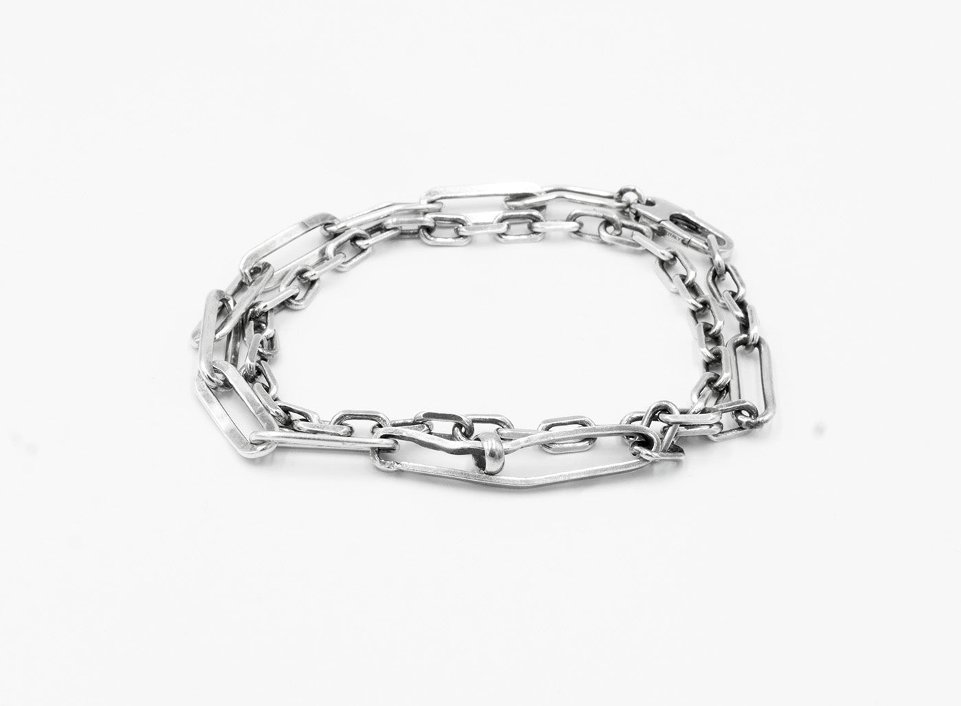 this sterling silver multi-link bracelet features small and large anchor chain details. this piece also converts into a necklace.
