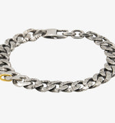 we are reimagining the classic curb chain with subtle details and hand work. this bracelet features hand forged distressed curb links and is finished with our signature 18k gold oval ring