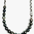 choker features a strand of 8.5mm grade a black tahitian pearls that connect to a round cable chain