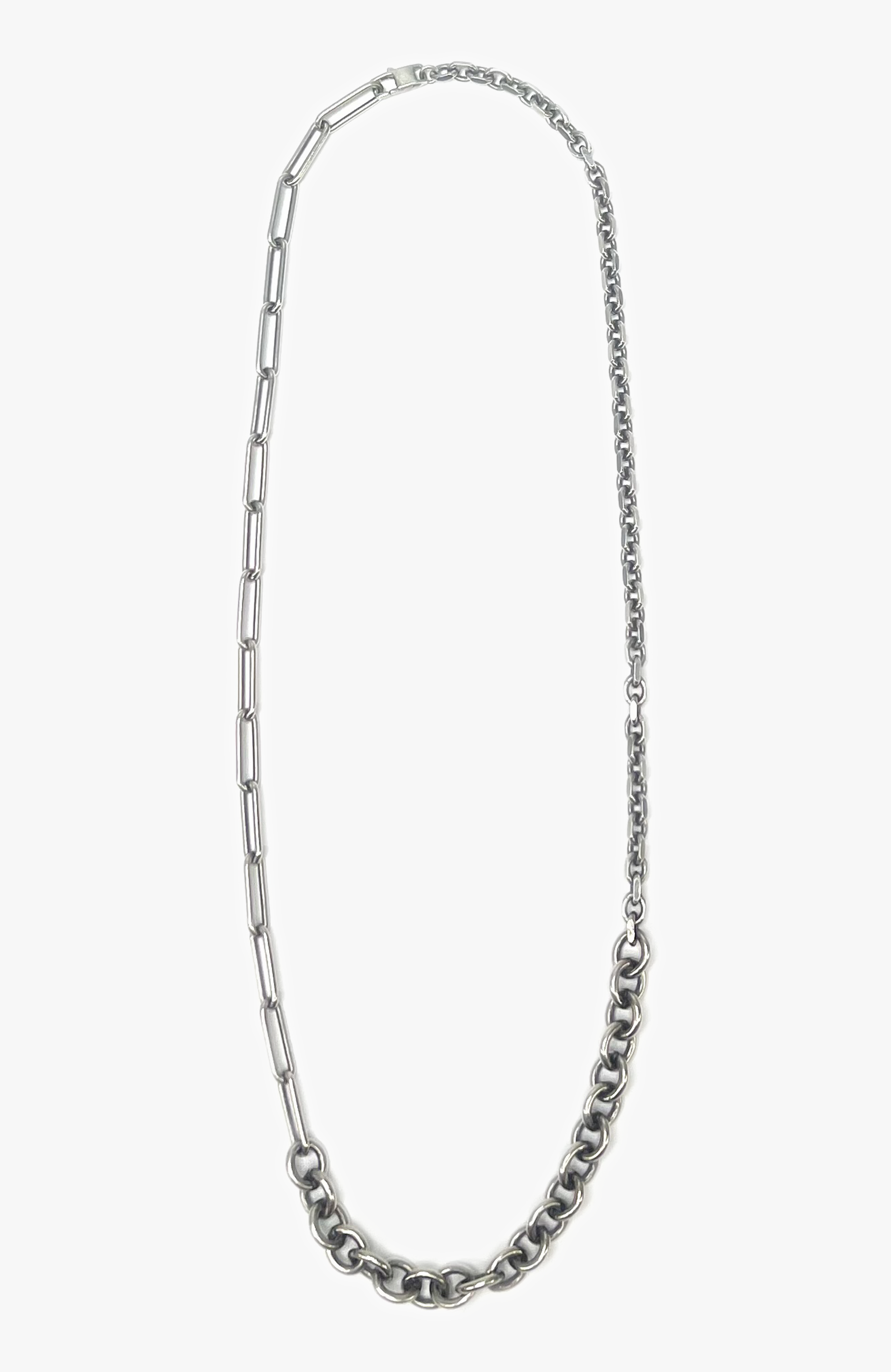 adjustable multi-chain necklace features elongated paperclip, cable, and diamond cut link chains