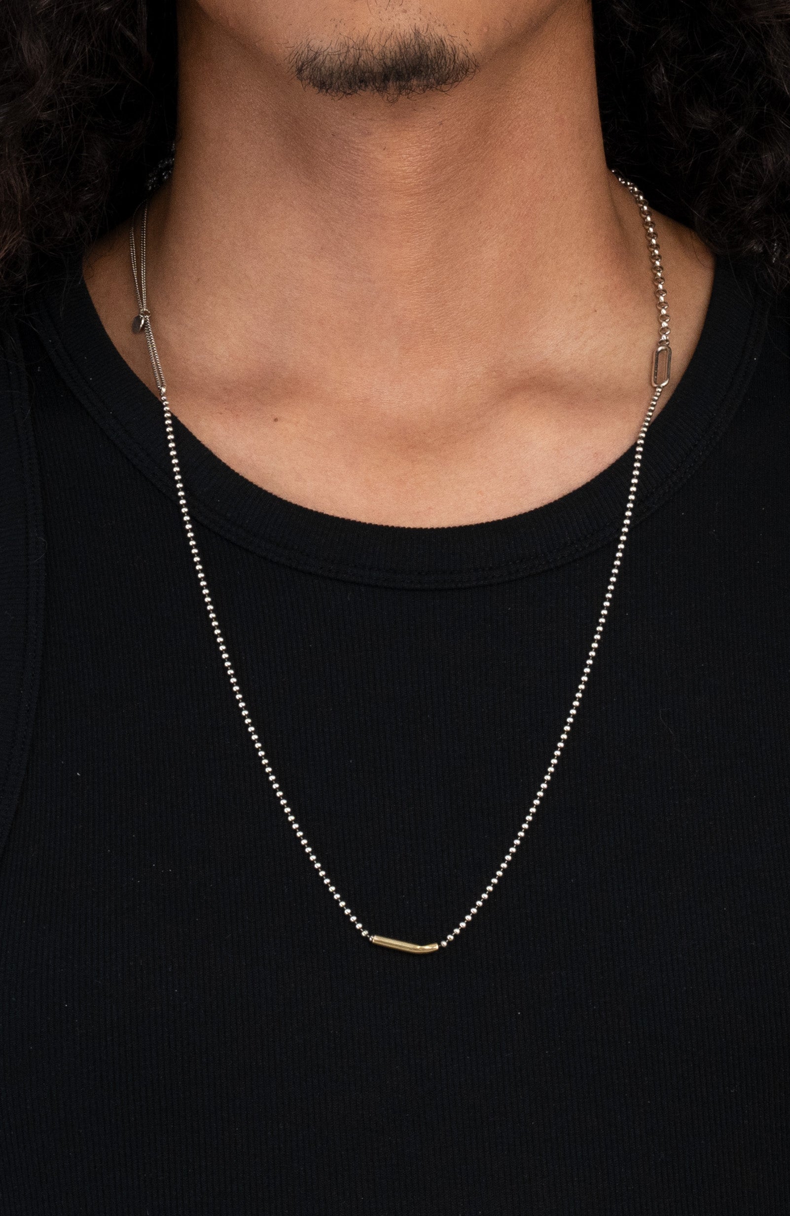 necklace is composed of a hand forged 1" solid 18k yellow gold bar that suspends from a sterling lariat and ball chain