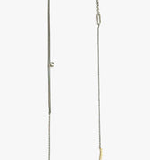 necklace is composed of a hand forged 1" solid 18k yellow gold bar that suspends from a sterling lariat and ball chain