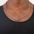 mixed chain/multi-wrap necklace features a sterling silver box chain, double strand curb and cable chain disrupted by a single emerald-cut iolite gemstone