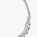 a sterling silver 13mm cuban link and cable chain are connected by a carabiner clasp with a single ruby gemstone accenting the larger chain