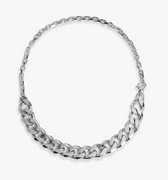 a sterling silver 13mm cuban link and cable chain are connected by a carabiner clasp with a single ruby gemstone accenting the larger chain