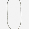 necklace is comprised of three separate chains including a thin double strand cable, more dense single strand cable and anchor chain, accented by an 18k yellow gold tube