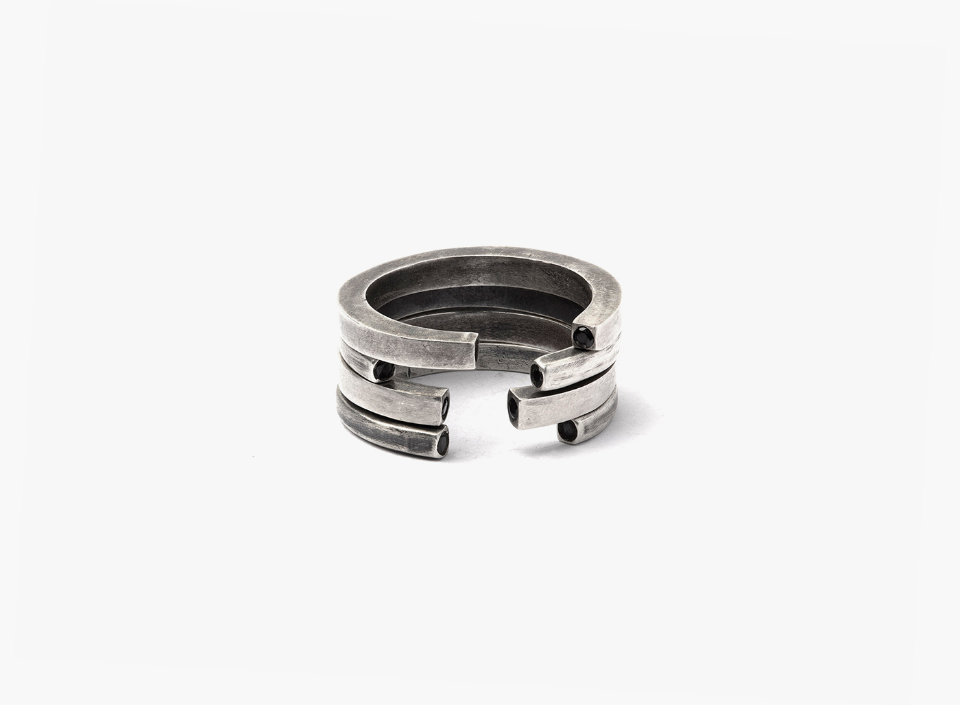 stack of four open rings features two black diamonds inset in each ring