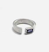 this open signet ring is hand forged and finished with an emerald-cut iolite gemstone