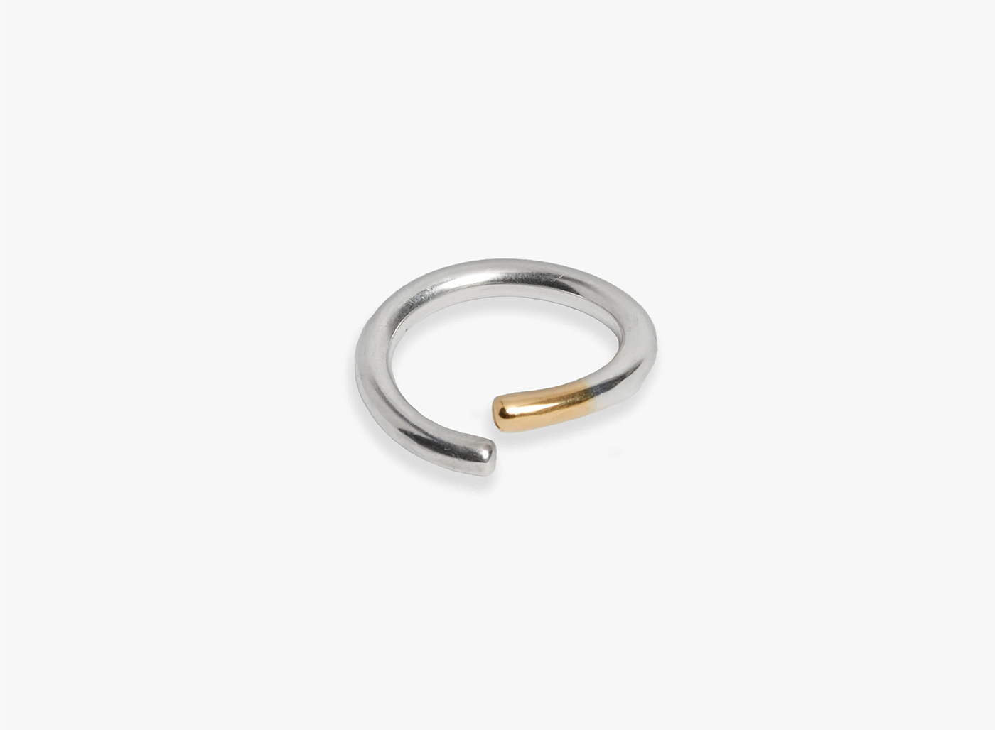 adjustable 10 gauge ring features a curved sterling silver bar, finished with an 18k yellow gold tip