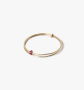 yellow gold double ring features a delicate ruby