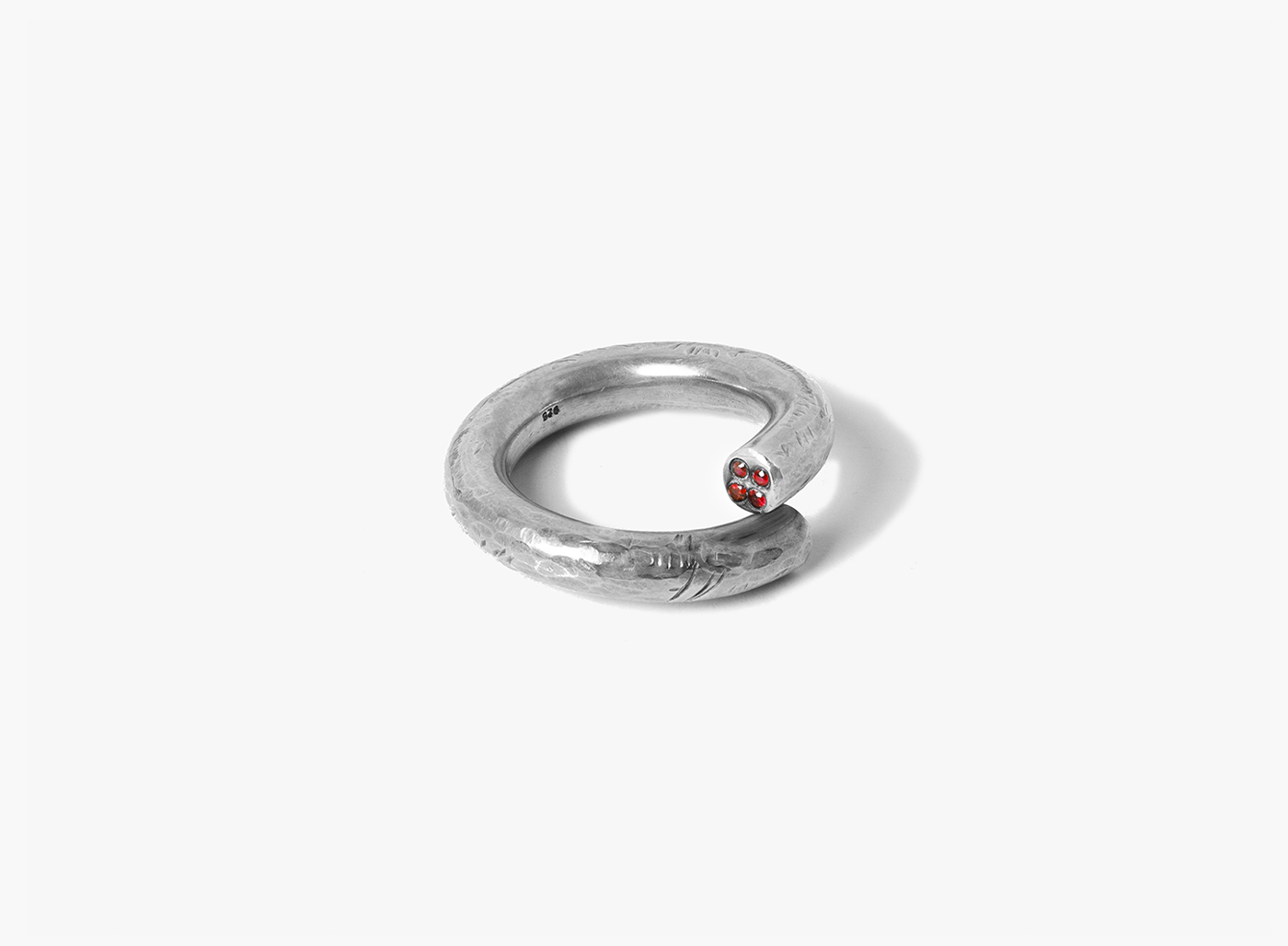 hand-distressed single band, wrapped silver ring features four rubies at the tip