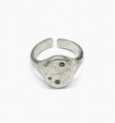 adjustable, hand forged and distressed sterling silver signet ring is set with asymmetrical black diamonds