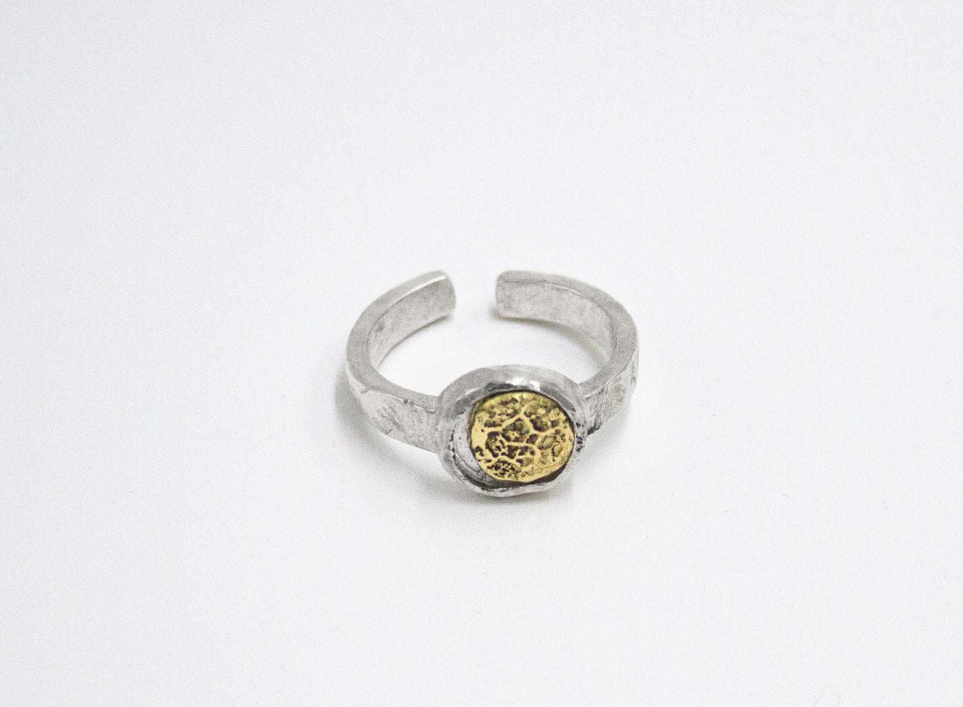 adjustable open ring features a solid 18k gold distressed detail inset in a circular sterling silver band