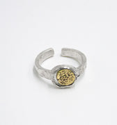 adjustable open ring features a solid 18k gold distressed detail inset in a circular sterling silver band