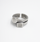 stacked open ring is made from reclaimed silver and features small circular and square signets that hug one another