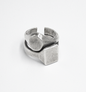 stacked open ring is made from reclaimed silver and features large circular and square signets that hug one another