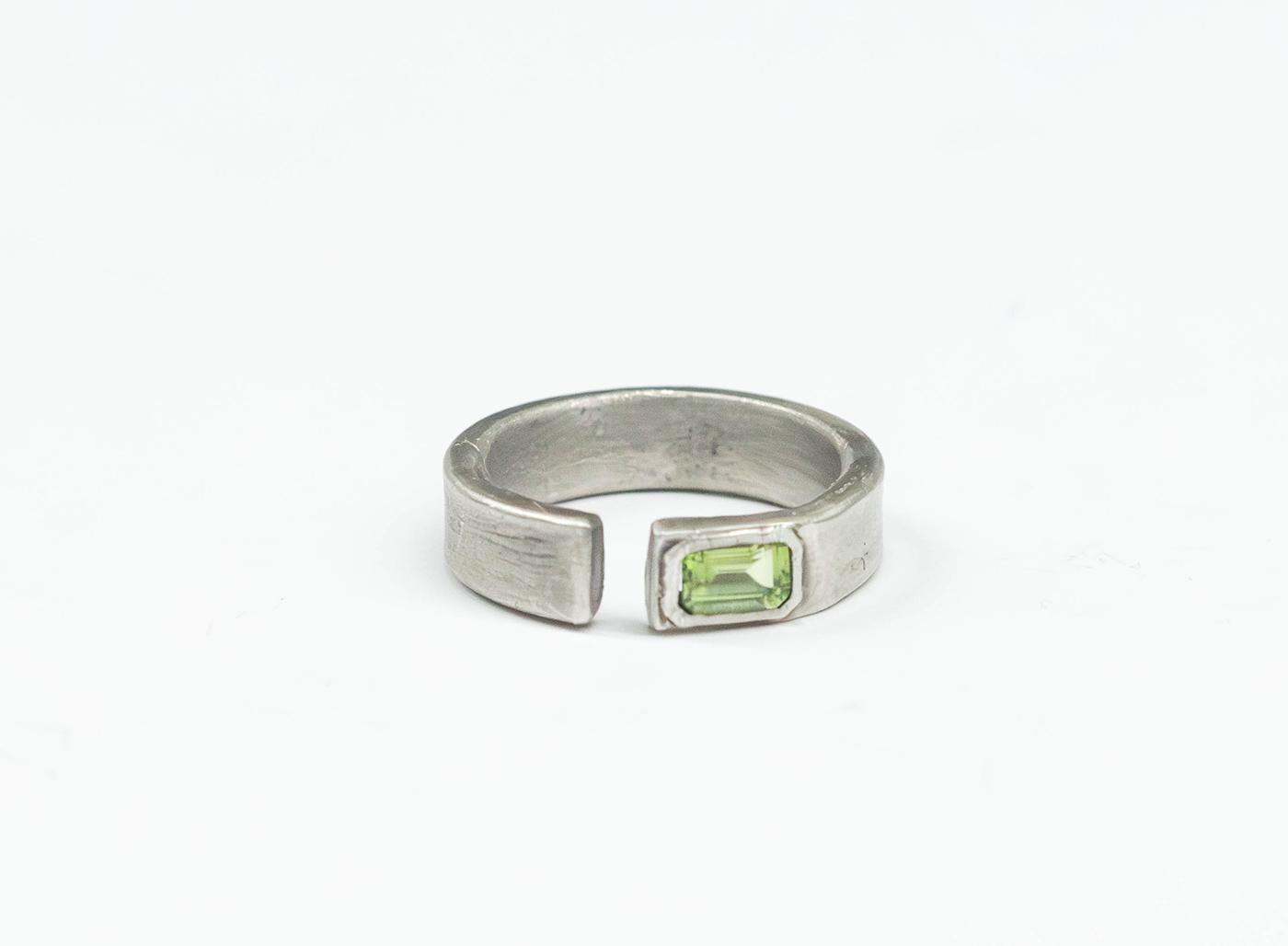 sterling silver open signet ring is hand forged and finished with an emerald-cut peridot stone